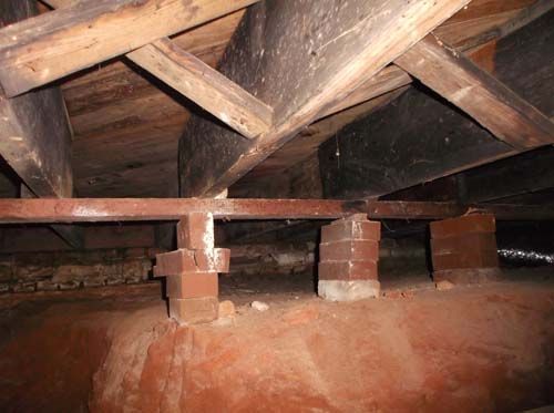 A wooden structure with bricks underneath it.