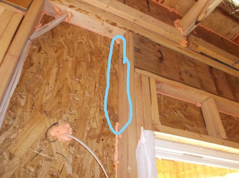 A blue arrow is pointing to a hole in a wooden wall.