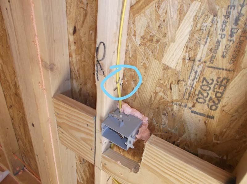 A close up of an electrical box on a wooden wall.