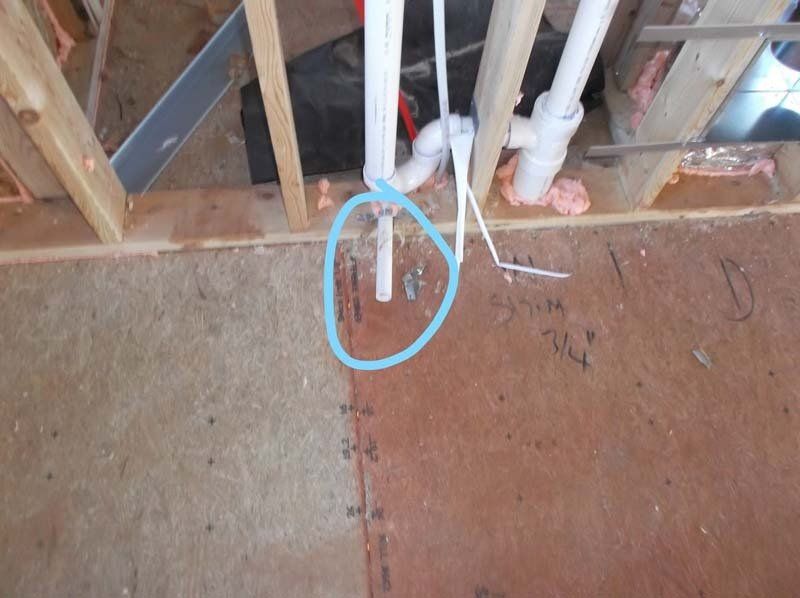 A picture of a plumbing pipe in a house under construction.