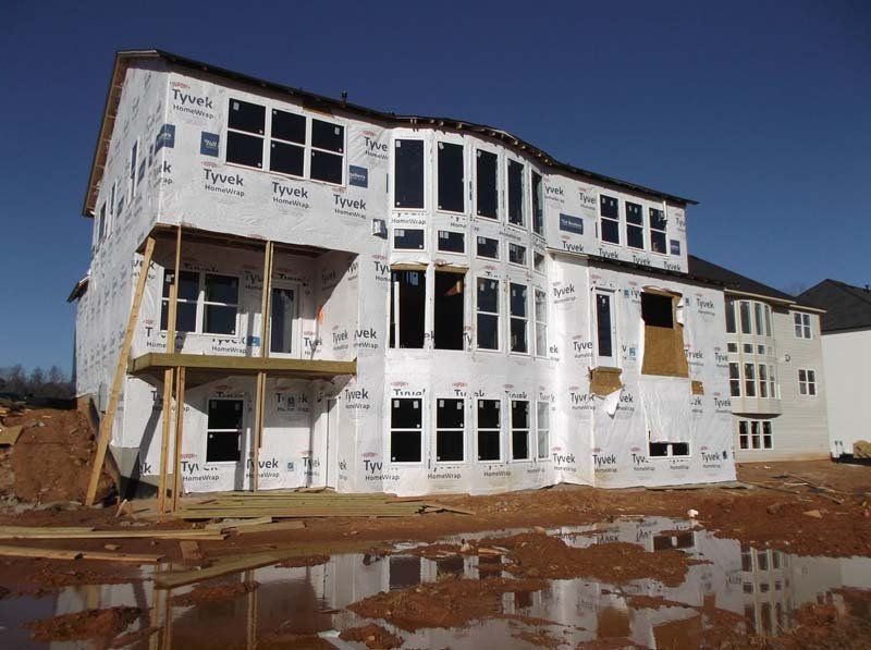 A large house is being built with a lot of windows