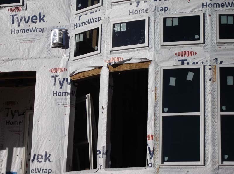 A building under construction with tyvek homewrap on it