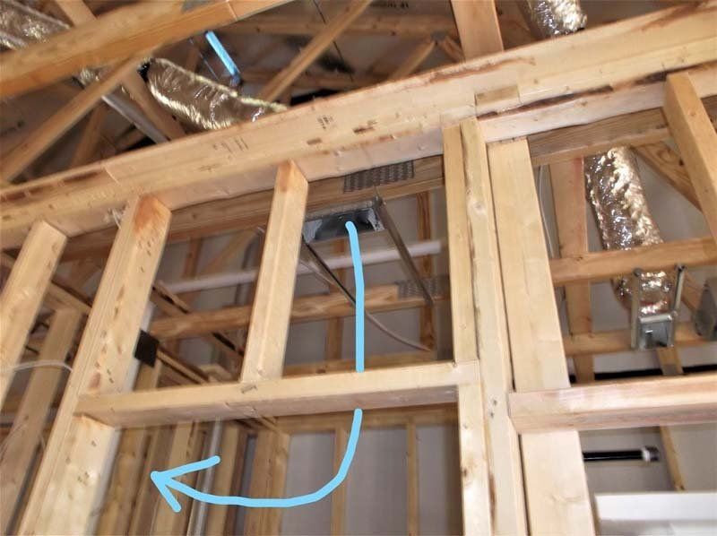 A picture of a house under construction with a blue arrow pointing to a hole in the ceiling.