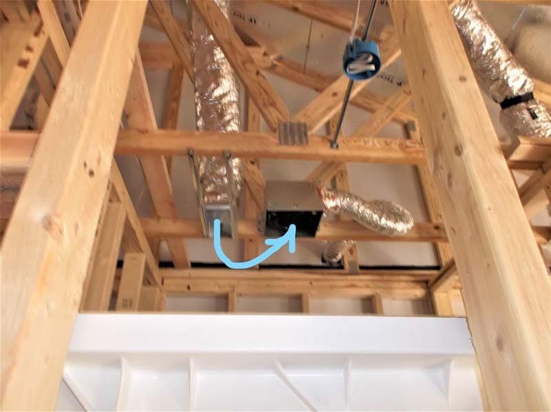 A wooden structure with a blue arrow pointing to a hole in the ceiling.