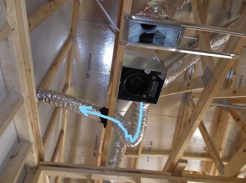 A picture of a ceiling with a blue arrow pointing to a fan