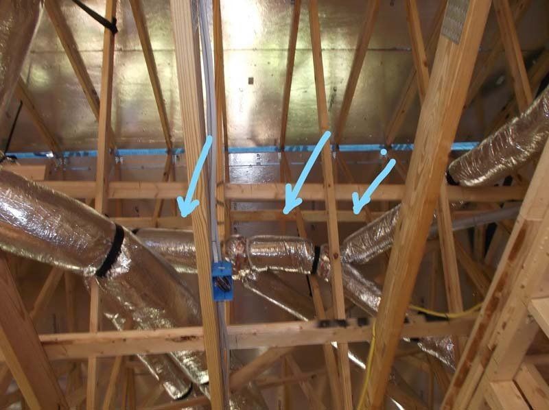 A ceiling with a lot of pipes going through it