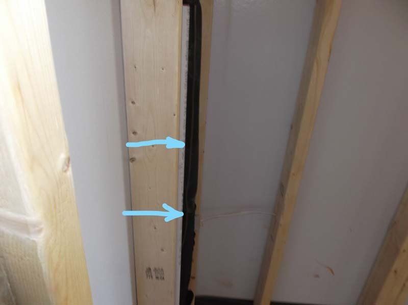 A close up of a wooden beam with arrows pointing up and down.