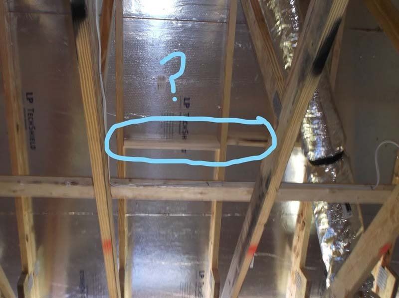 A picture of a ceiling with a question mark drawn on it.