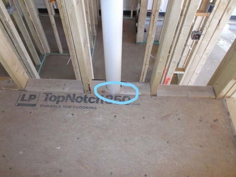 A blue circle shows where a pipe is in a house under construction