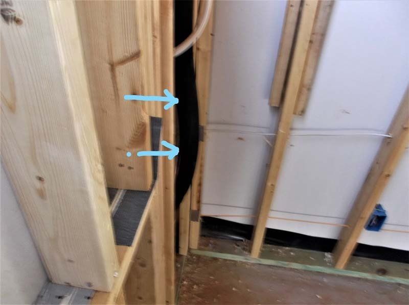 A wooden wall with arrows pointing up and down