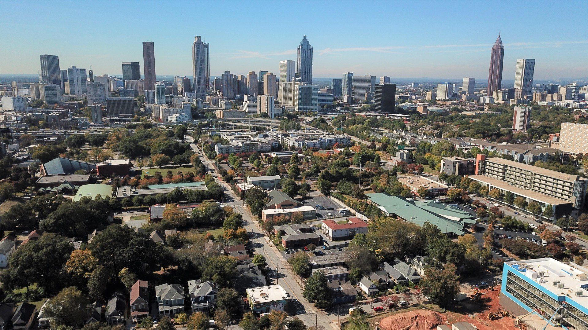 An aerial view of a city with lots of buildings and trees
