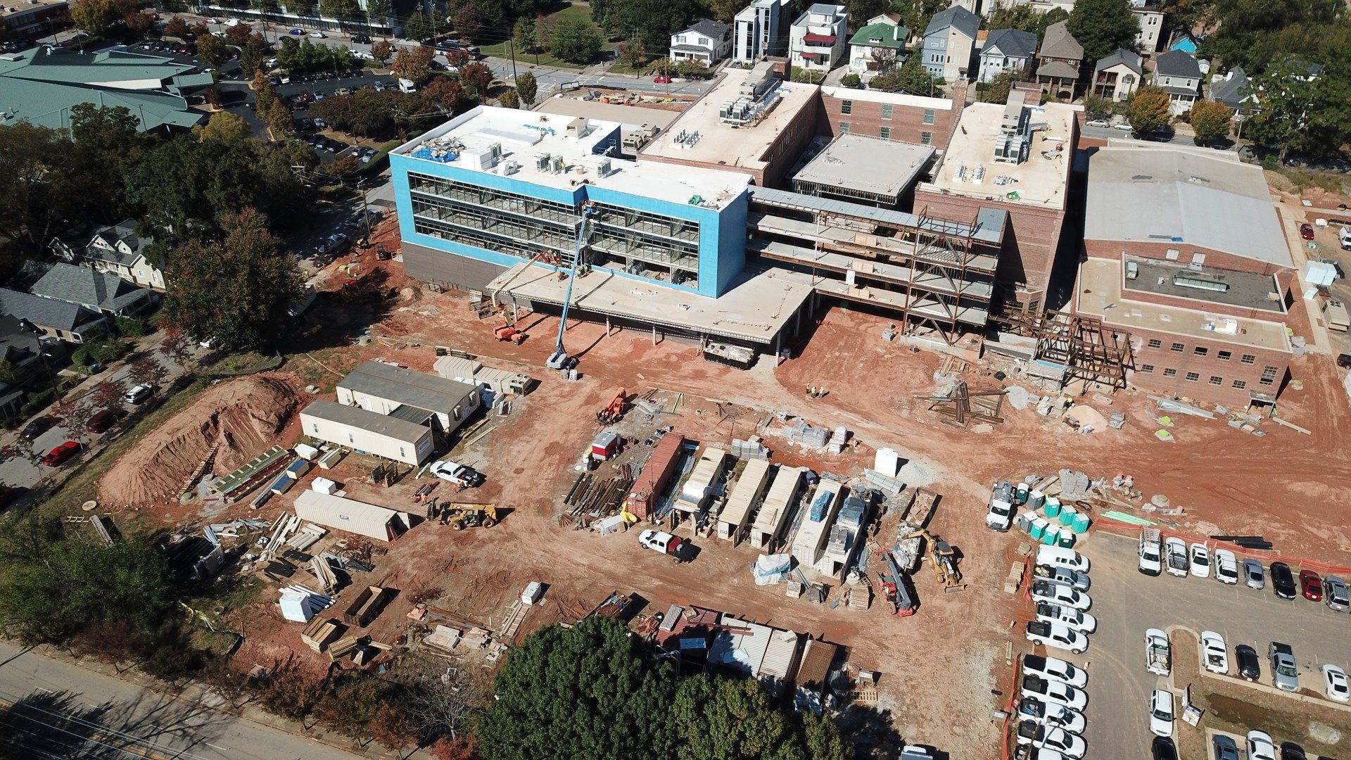 An aerial view of a large building under construction in a city.