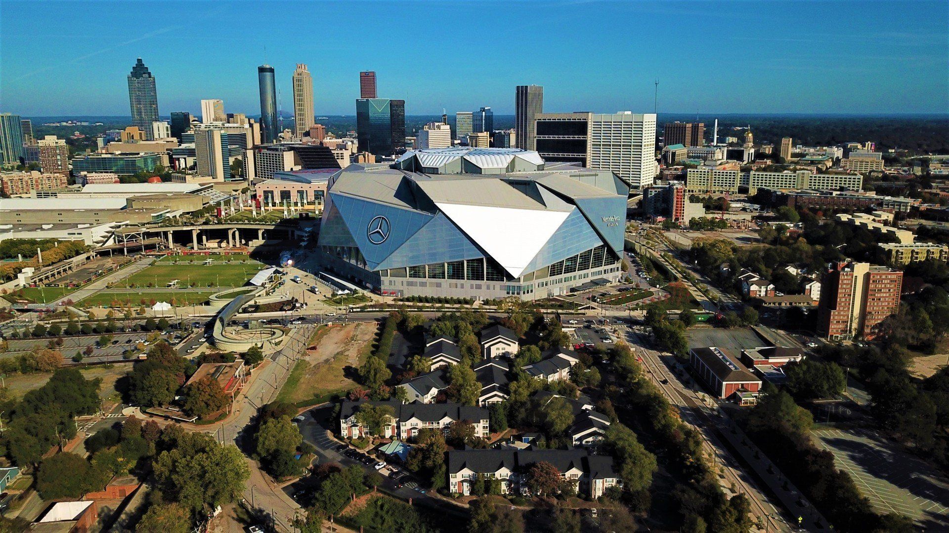 An aerial view of a large stadium in a city