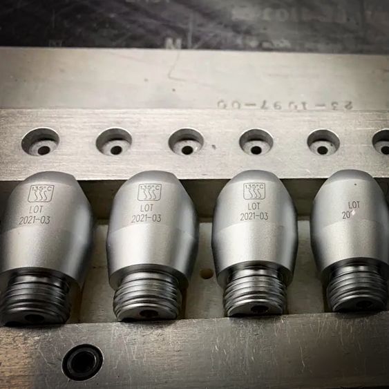 A machine is cutting a piece of metal with a laser.