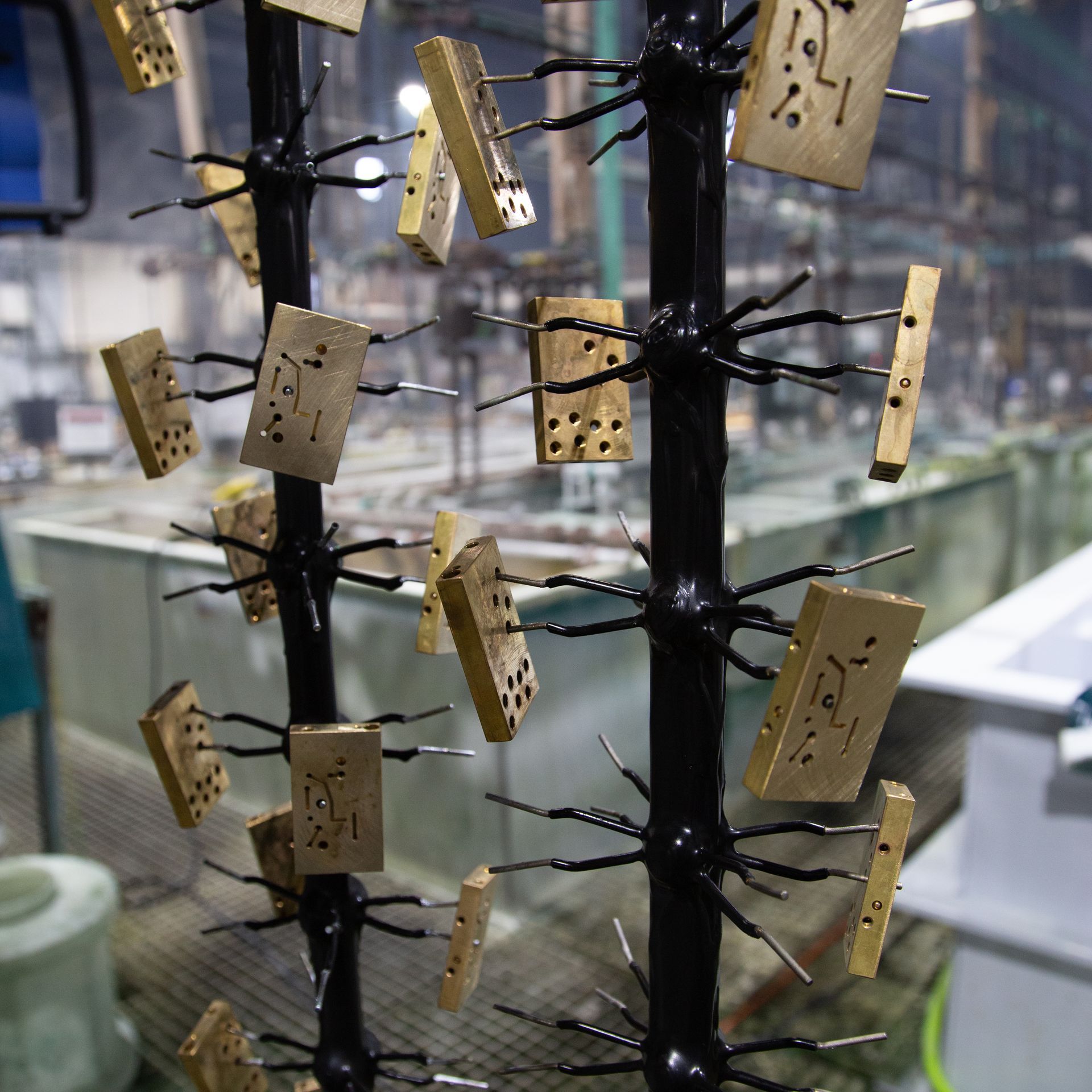A machine is cutting a piece of metal in a factory.