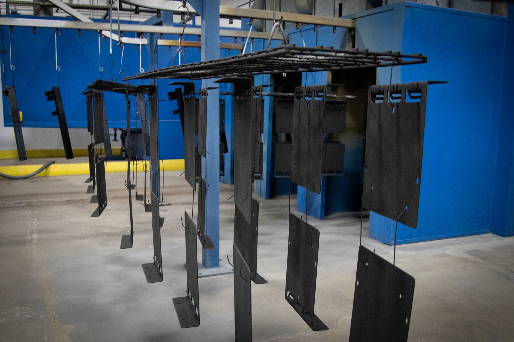 A blue room with a lot of metal hanging from the ceiling