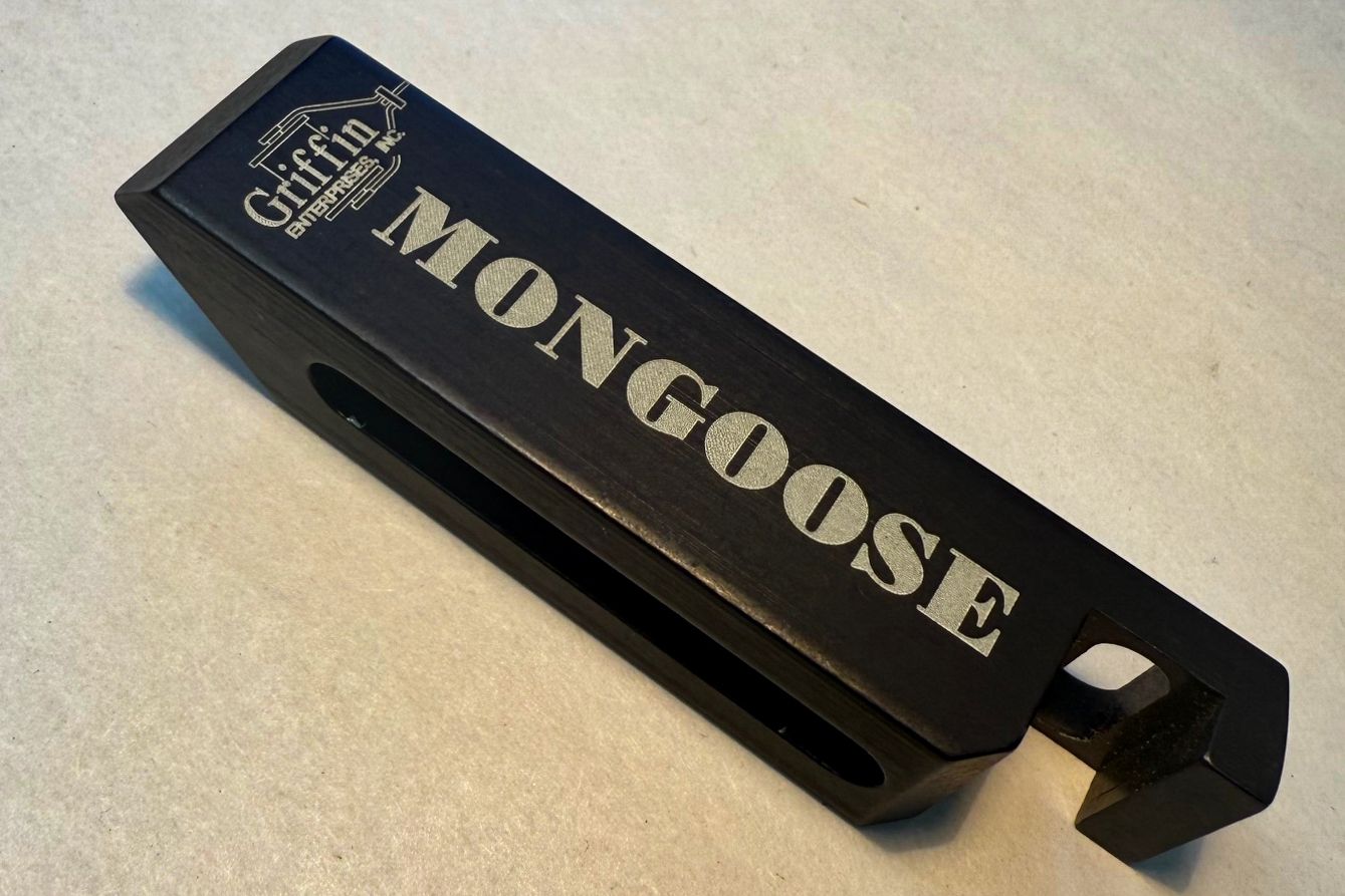 A person is grinding a piece of metal with a grinder.