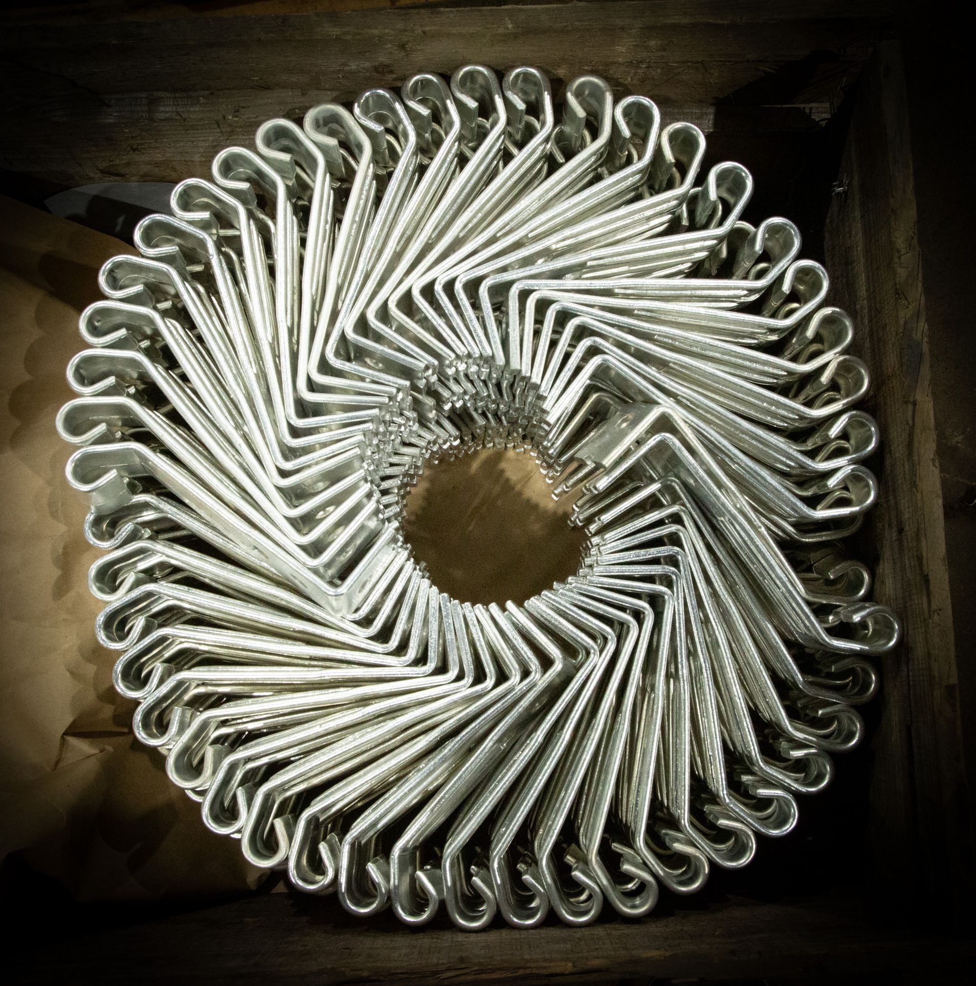 A machine is cutting a piece of metal with sparks coming out of it.