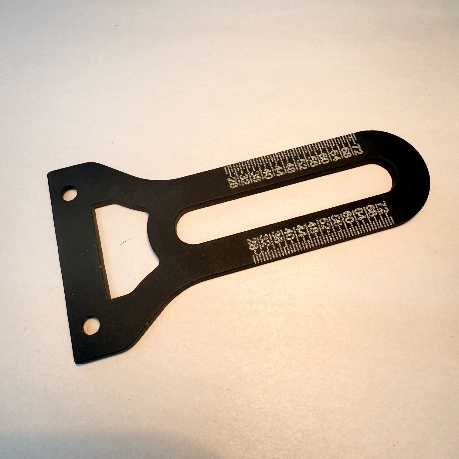 A machine is cutting a piece of metal with sparks coming out of it.