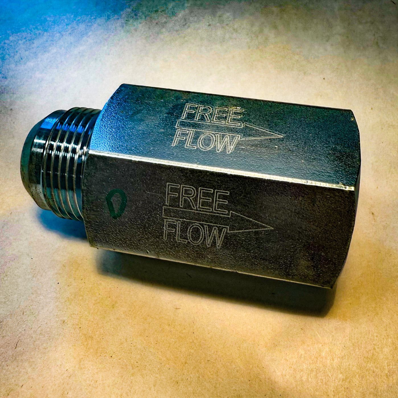 A man is grinding a piece of metal in a factory.