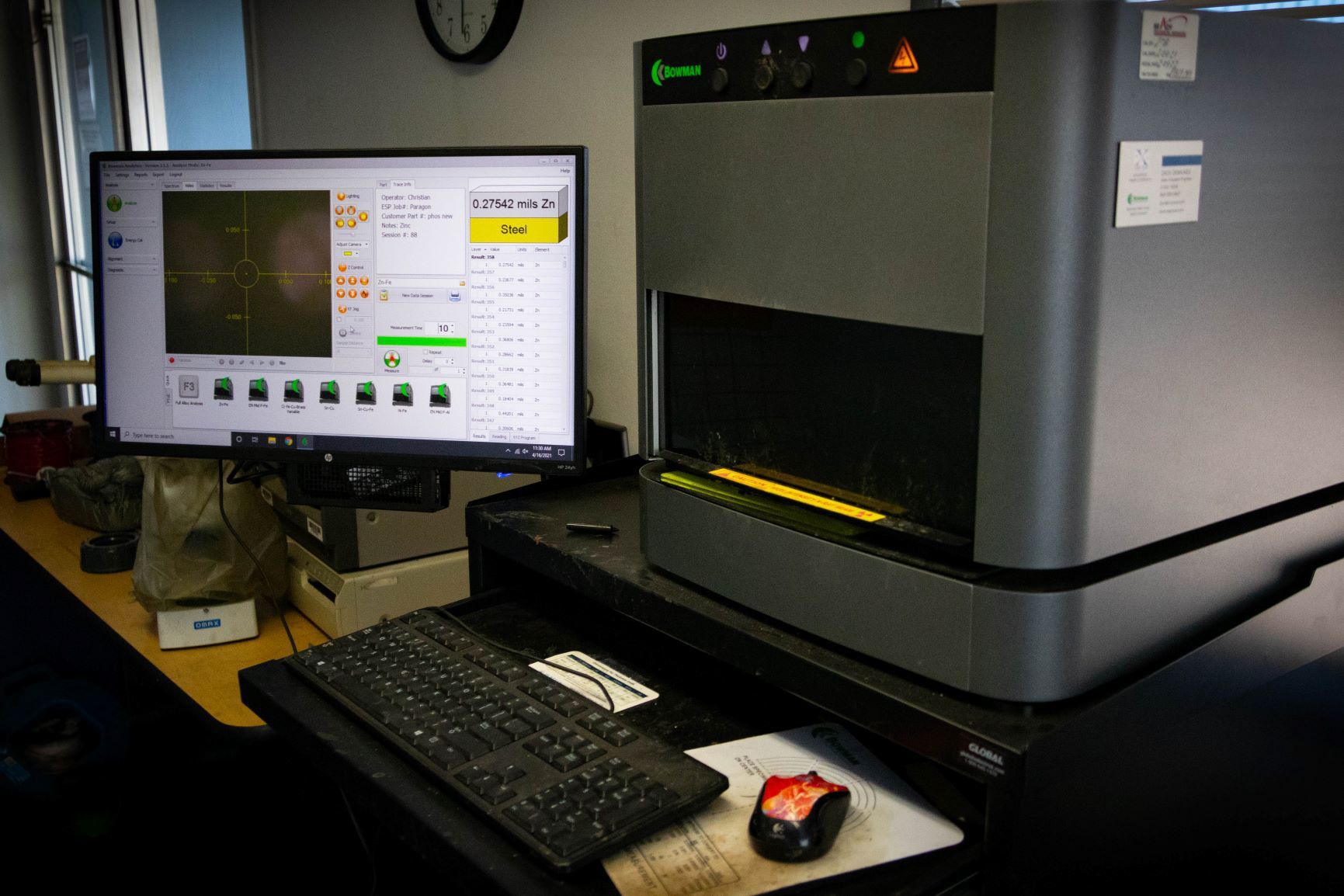 A machine is cutting a piece of metal with sparks coming out of it.