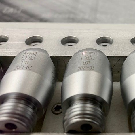 A man is working on a machine in a factory.