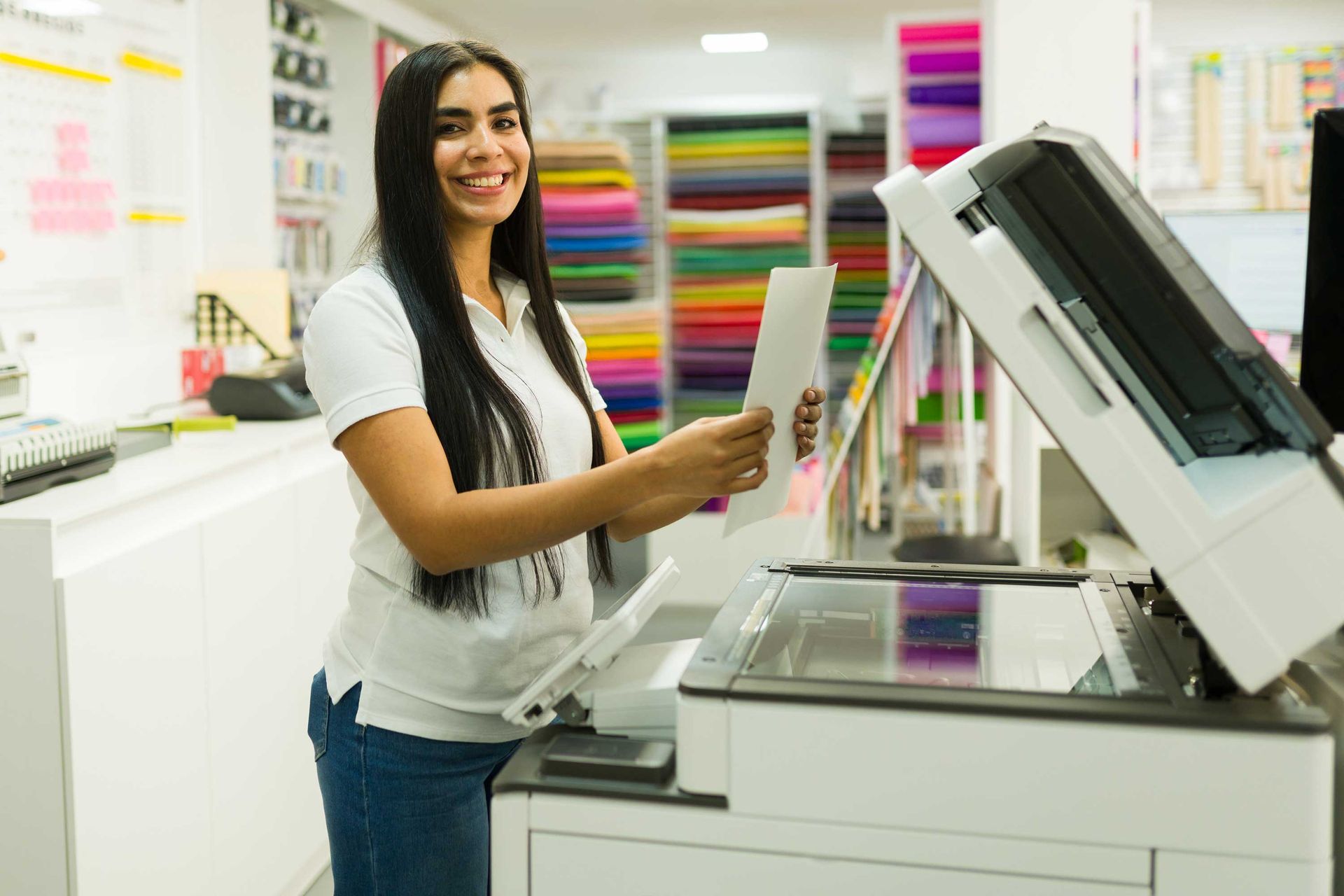 A woman is working at a printing shop.