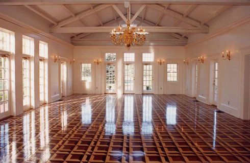 A hallway of beautiful parquet hardwood floors.