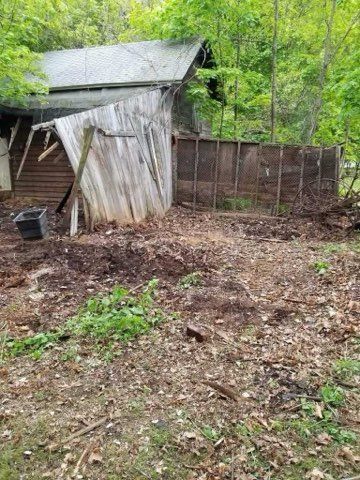 There is a shed in the middle of the woods.