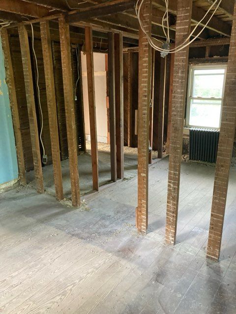 A room with a lot of wooden beams and a window.