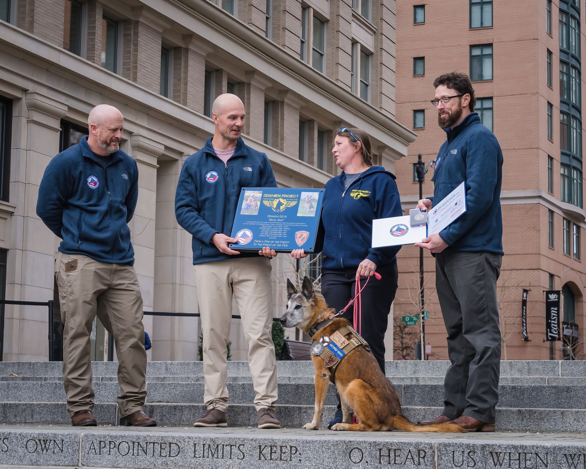 A group of people standing next to a dog holding signs