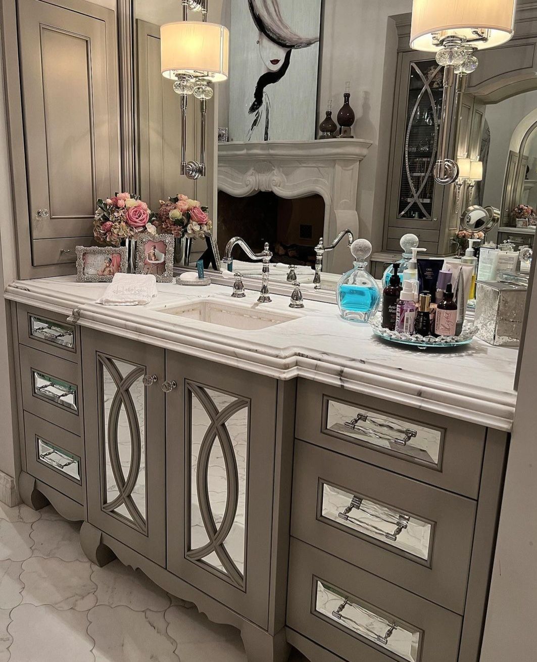 A bathroom with two sinks , a mirror and a fireplace.