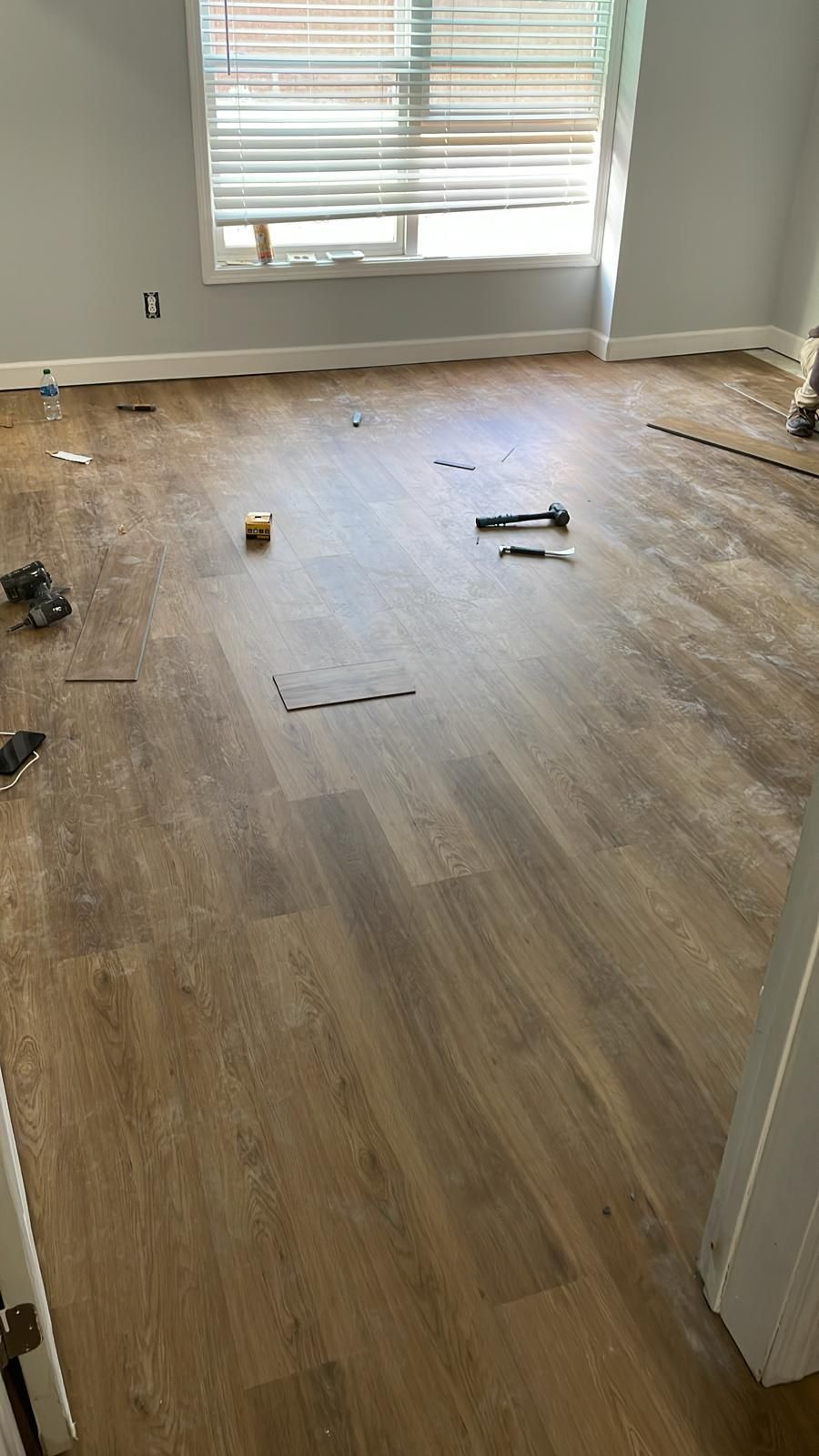 A room with a wooden floor and a window.