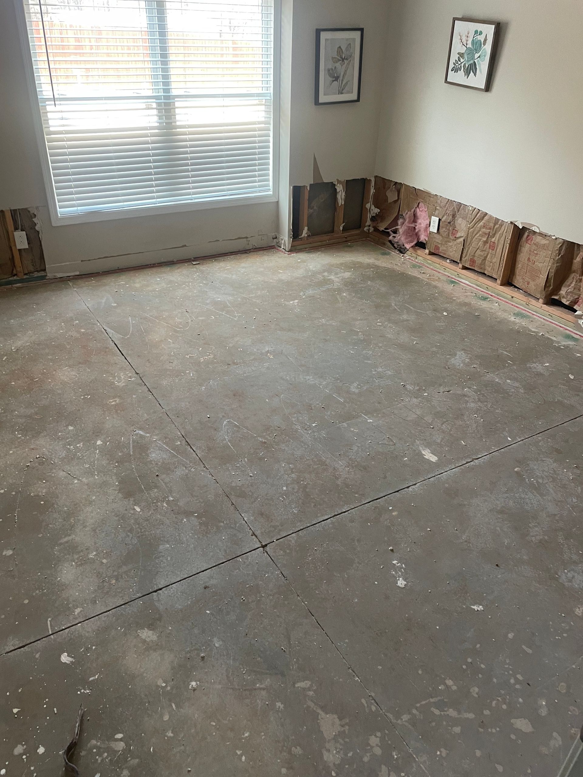 A room with a concrete floor and a window.