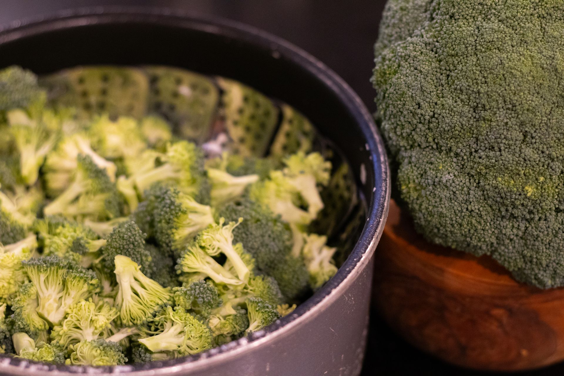 Stove pot with broccoli inside ready to be steamed on the stovetop