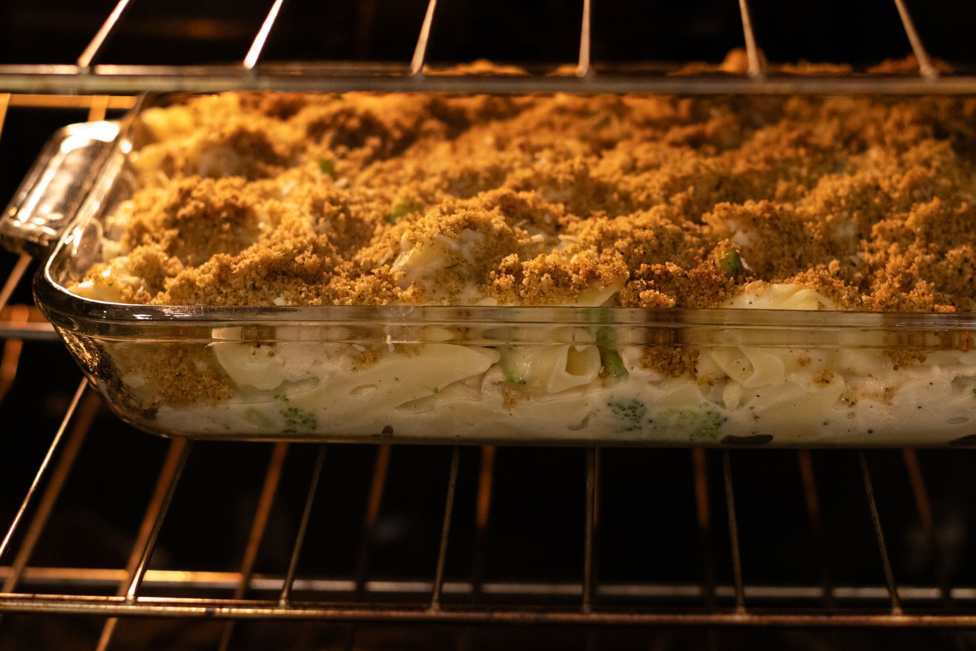 Cooking tray filled with chicken and broccoli Alfredo bake in the oven