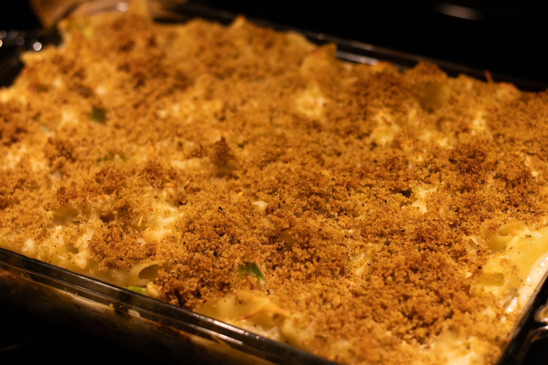 Baking pan filled with chicken and broccoli Alfredo bake in an oven