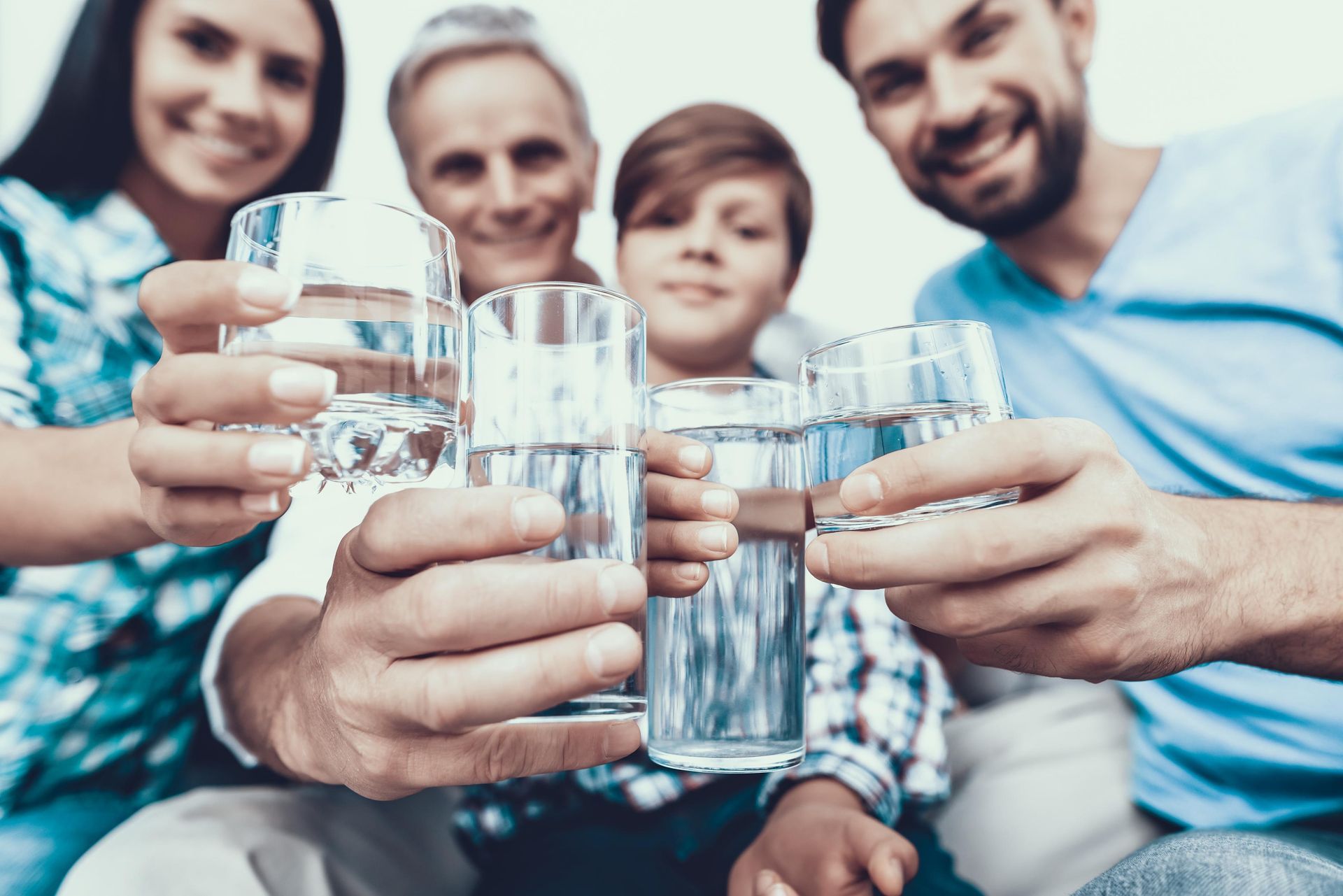 A family is toasting with glasses of water.