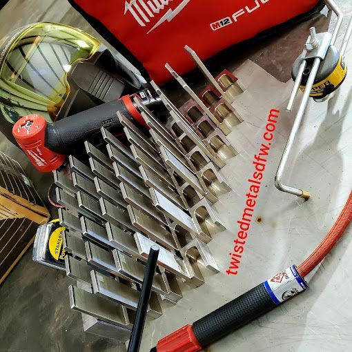 A piece of metal is being bent by a machine