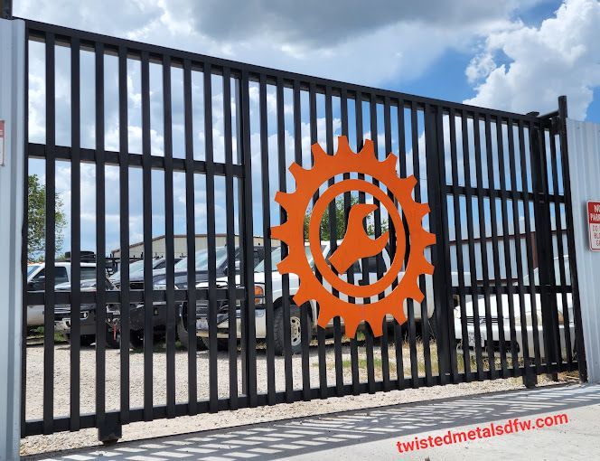 A black wrought iron gate with gold dots on it