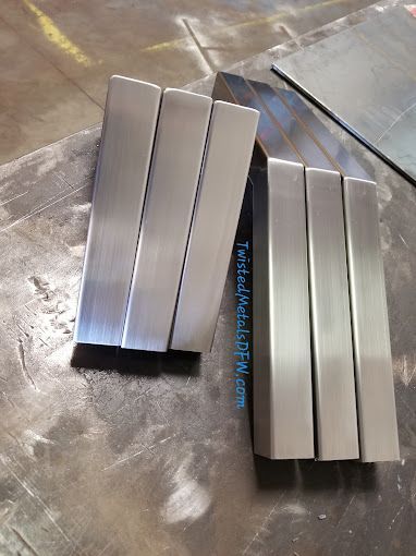 A man is grinding a metal fence with a grinder.