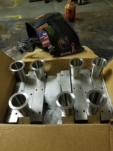 A bunch of metal springs are lined up on a table