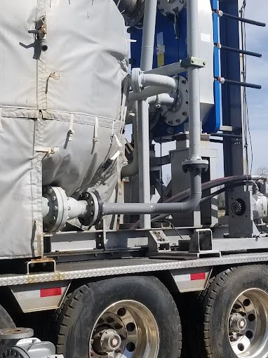 A bunch of stainless steel pipes are stacked on top of each other.