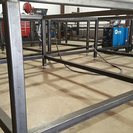 A close up of a metal structure sitting on the ground.