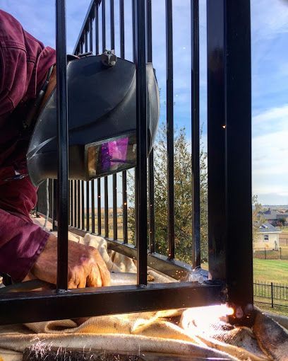 A person is welding a piece of metal on the floor.