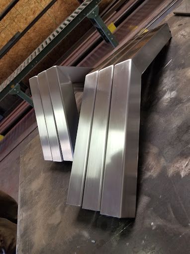 A conveyor belt with a bunch of metal pieces on it