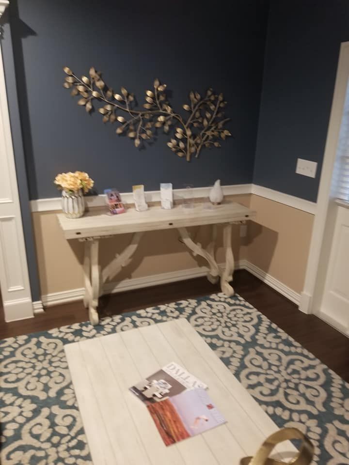 A living room with a white table and a blue wall