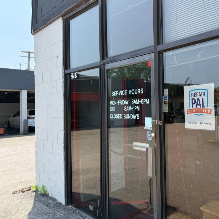 A storefront with glass door, service hours posted: Mon-Fri 8am-6pm, Sat 8am-1pm, closed Sundays. | Gravity Service Center