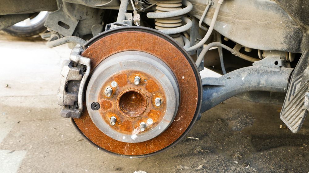 Brake service in Lake Mills, WI by Topel's Towing and Repair. Image of a rusty brake rotor 