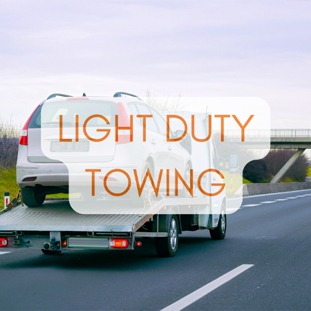 Towing service station in Lake Mills, WI? Topel's Towing & Repair, Inc. A light-duty tow truck transporting a car on a flatbed, suitable for smaller vehicles.
